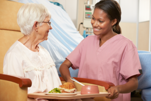 caregiver preparing food for her patient